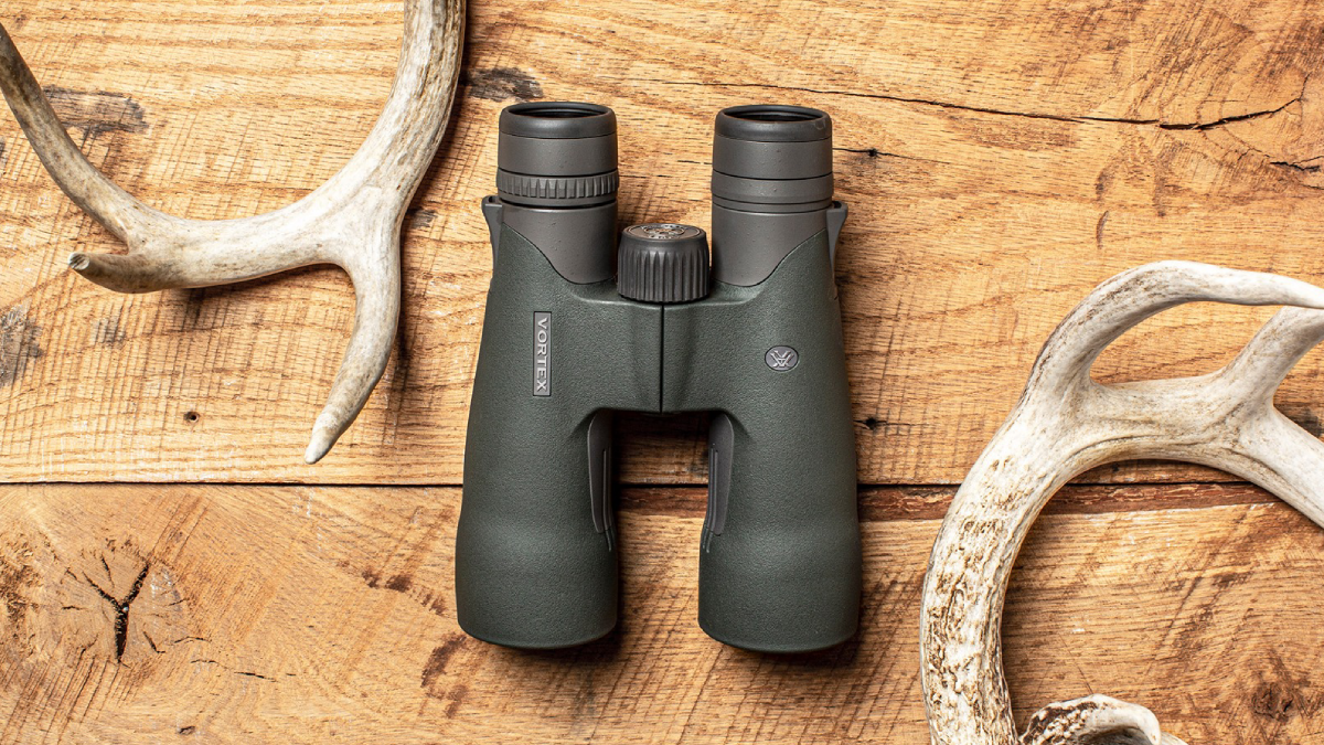 Vortex Diamondback Binoculars sitting on wood table with antlers