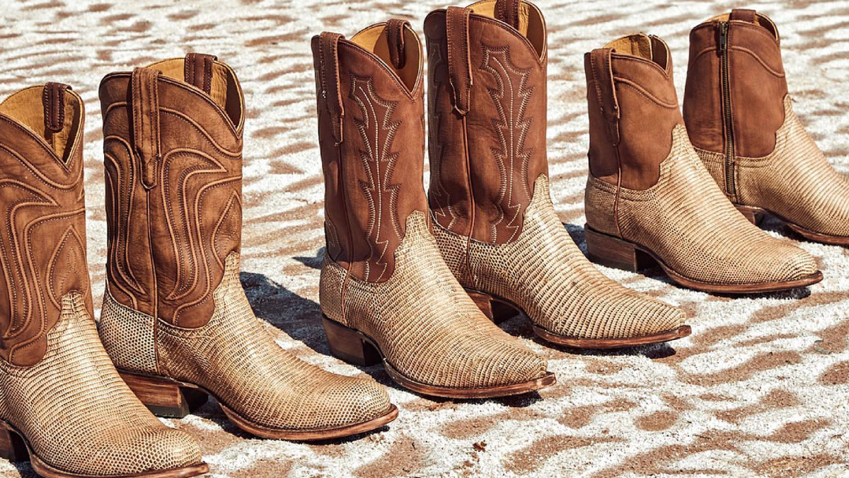 Tecovas cowboy boots lined up on brick