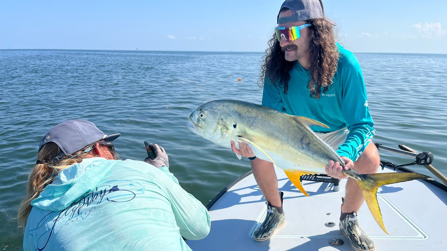 Photo of an angler posing with a crevalle jack he caught
