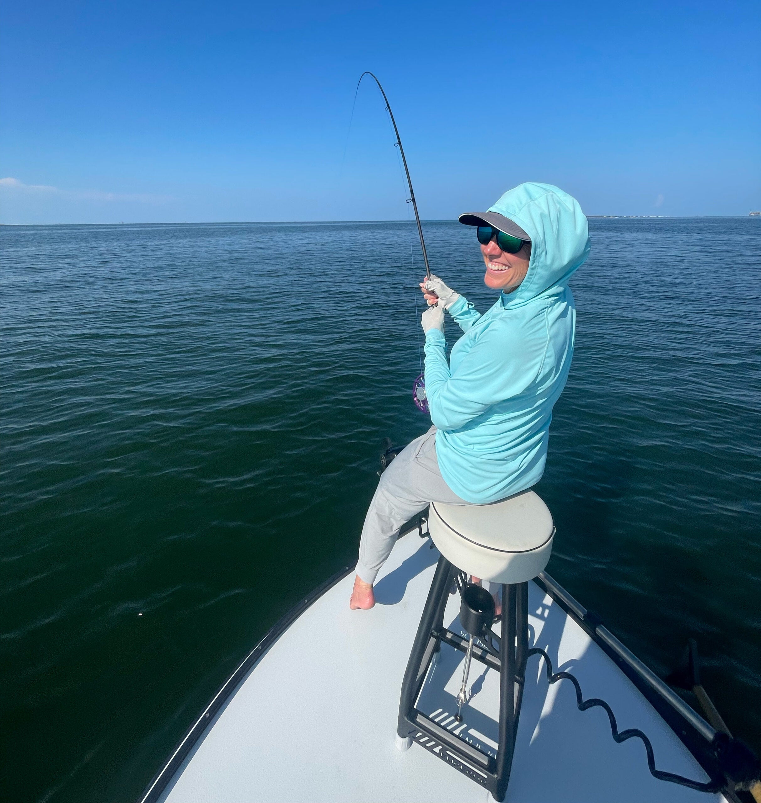 Photo of angler reeling in a crevalle jack