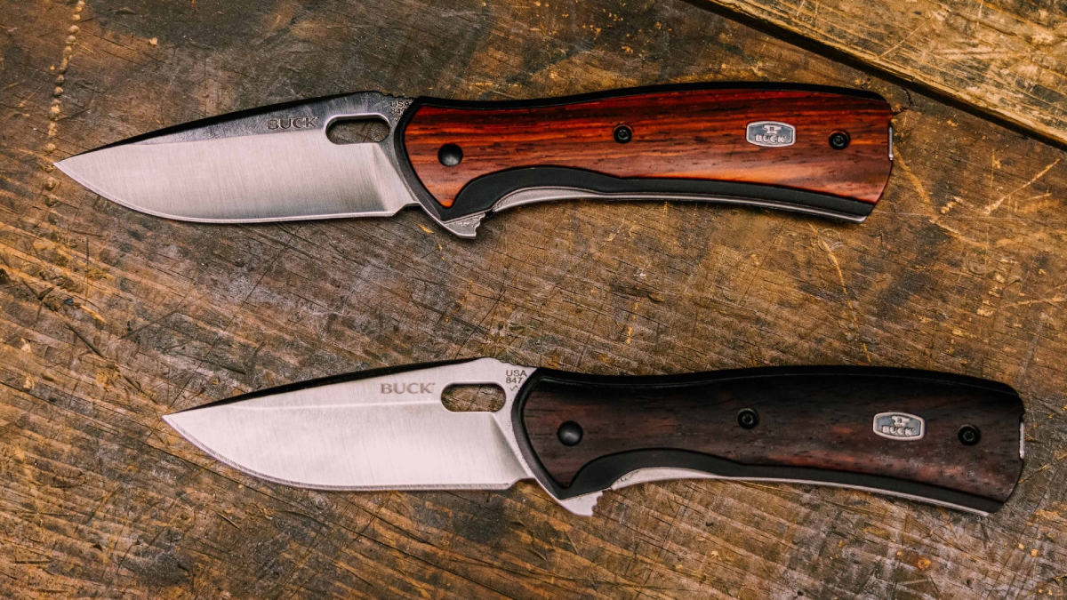 Buck Knives folding knives sitting on wood