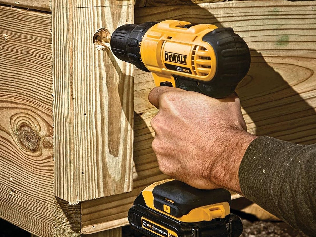 A Dewalt Cordless Drill working on some wooden boards