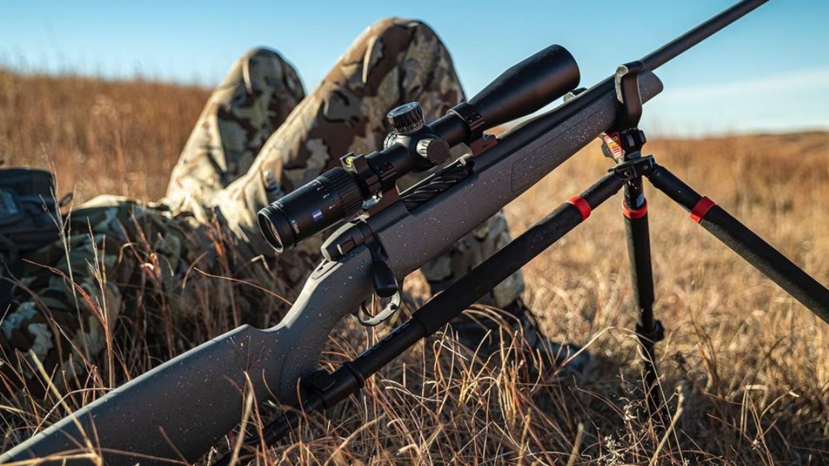 A Weatherby Vanguard rifle sitting in a field.
