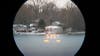A view of a home across a lake through the Maven RF.1 rangefinder. 