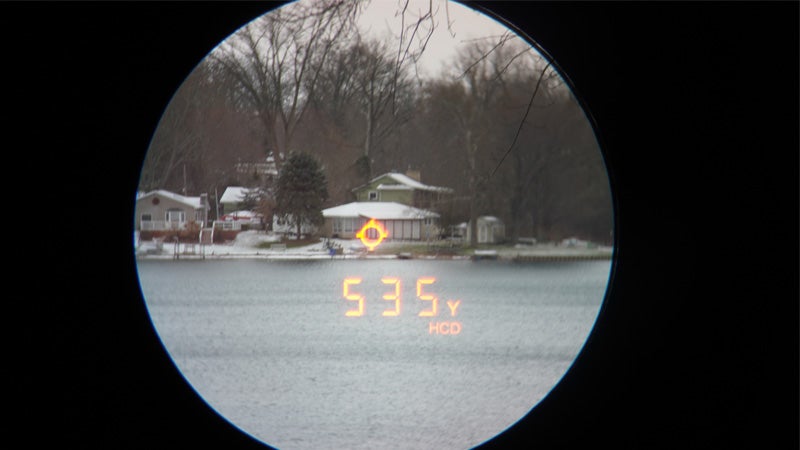 The view through a Vortex Razor HD 4000 of a house across a lake on a snowy day. 