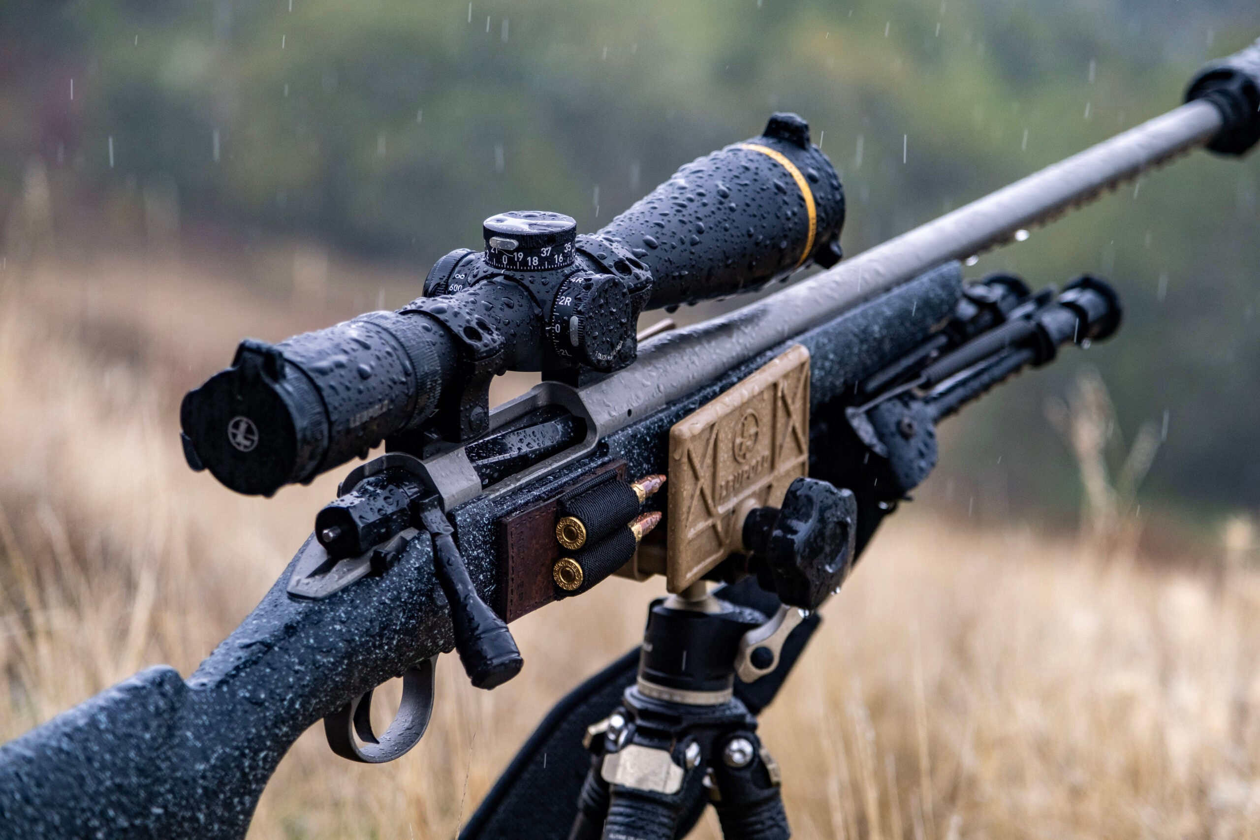 A Nosler Model 21 rifle with Leupold scope resting on a shooting tripod