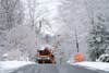 A power crews works to to repair an electrical line after winter snowstorm