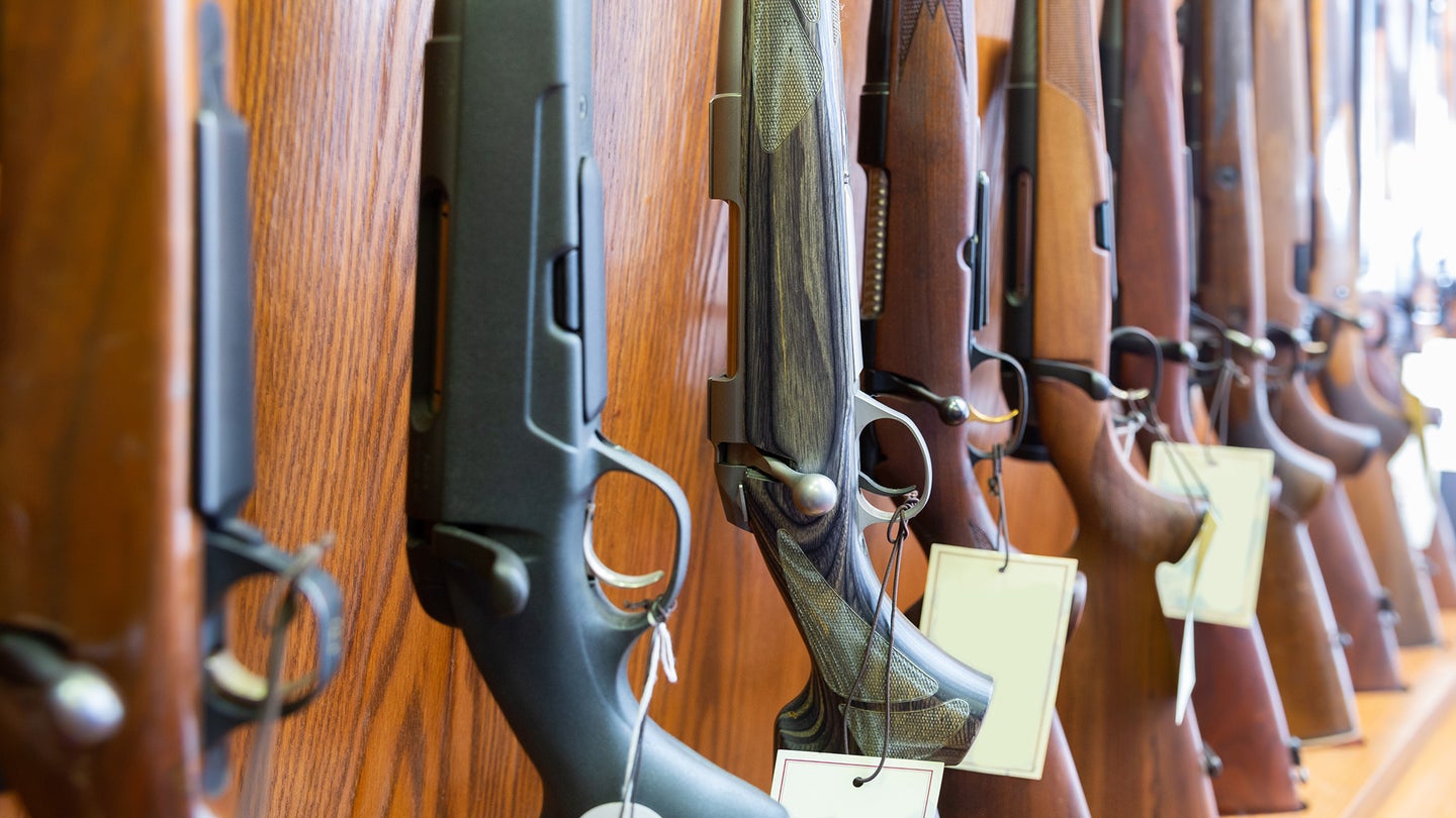 Photos of rifles lined up at a gun store