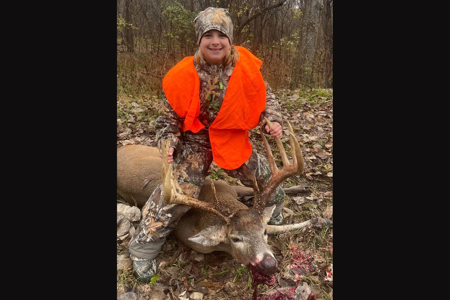 A 10-year-old hunter poses with an 11-point buck.