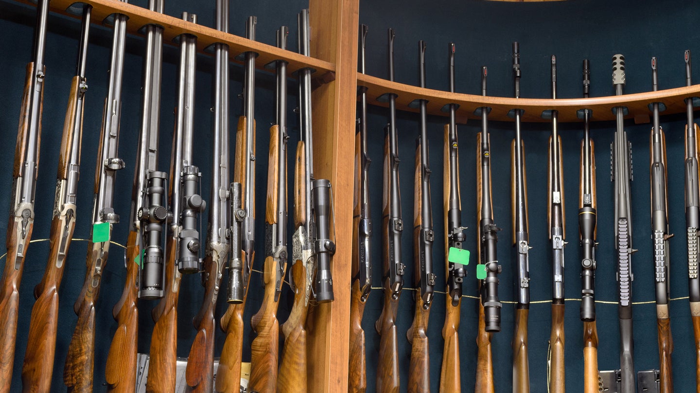 A rack of many different types of rifles in a gun store