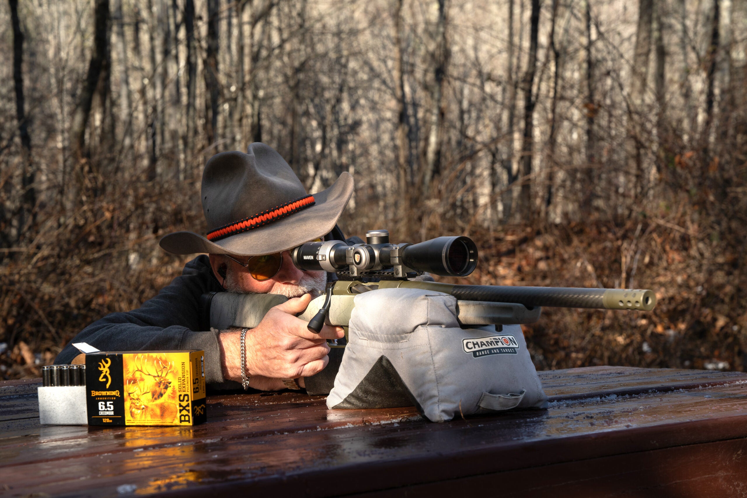 Shooter in cowboy hat fires the Springfield Armory Model 2020 Redline rifle from a bench rest