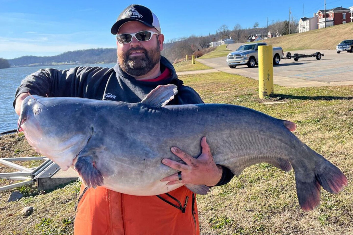 A West Virginia angler poses with a record-breaking blue catfish caught in the Ohio River.