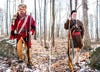 Portraits of two hunters in traditional flintlock hunting garb and woods in background