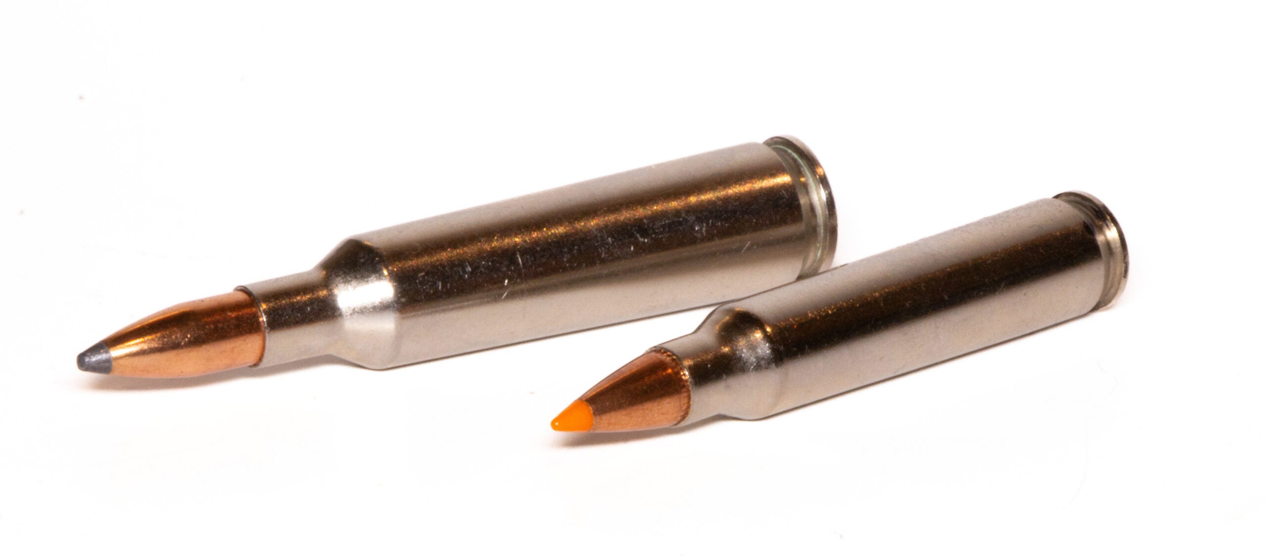 22-250 cartridge on left and 223 cartridge on right, both on a white background