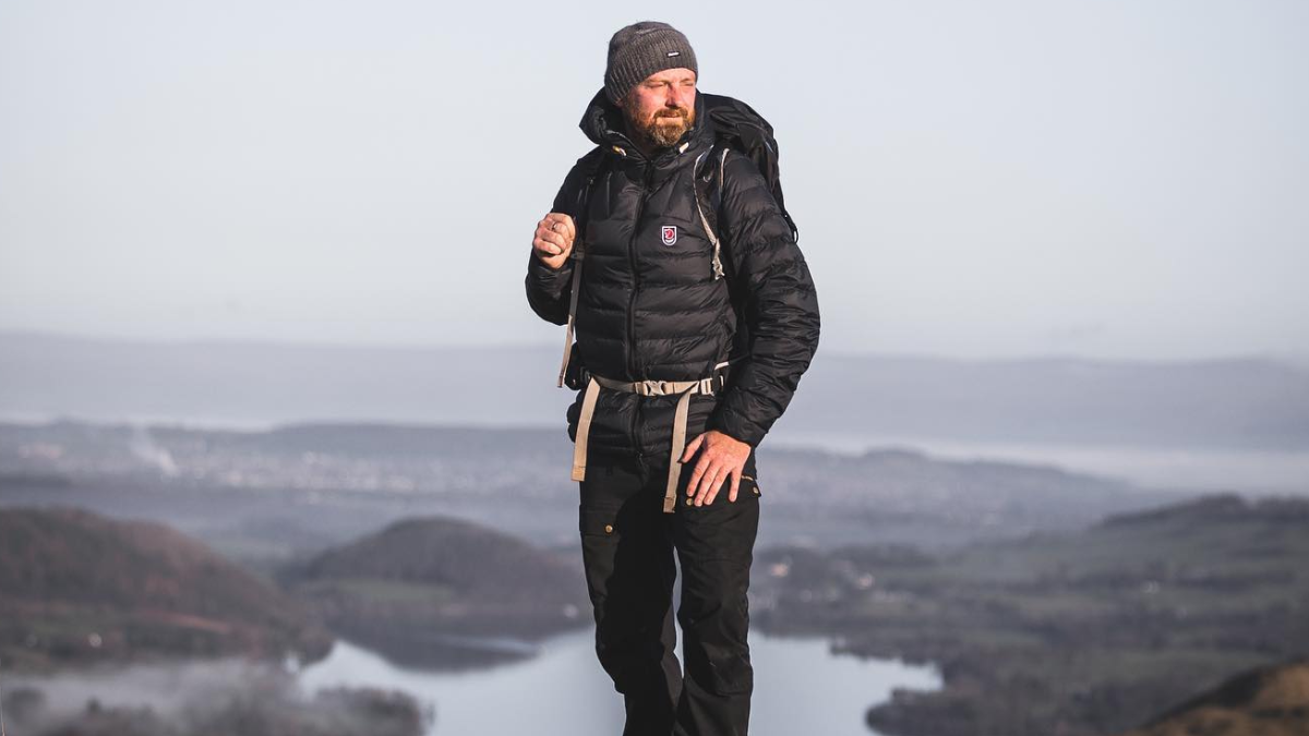 Male hiker wearing Fjallraven Down Jacket