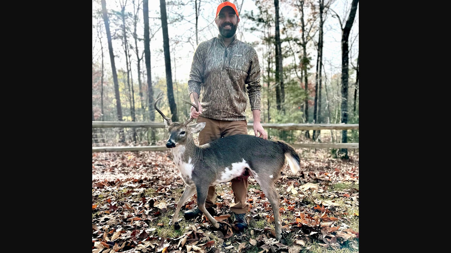 A hunter poses with a rare piebald dwarf deer taken in Alabama.