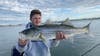 angler holding striped bass