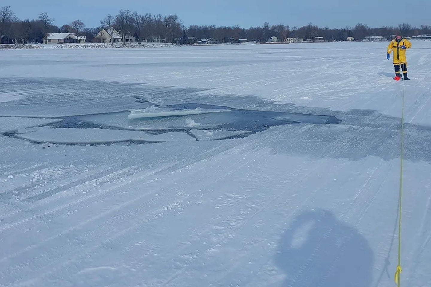Emergency responders stand on a partially frozen mille lacs lake.