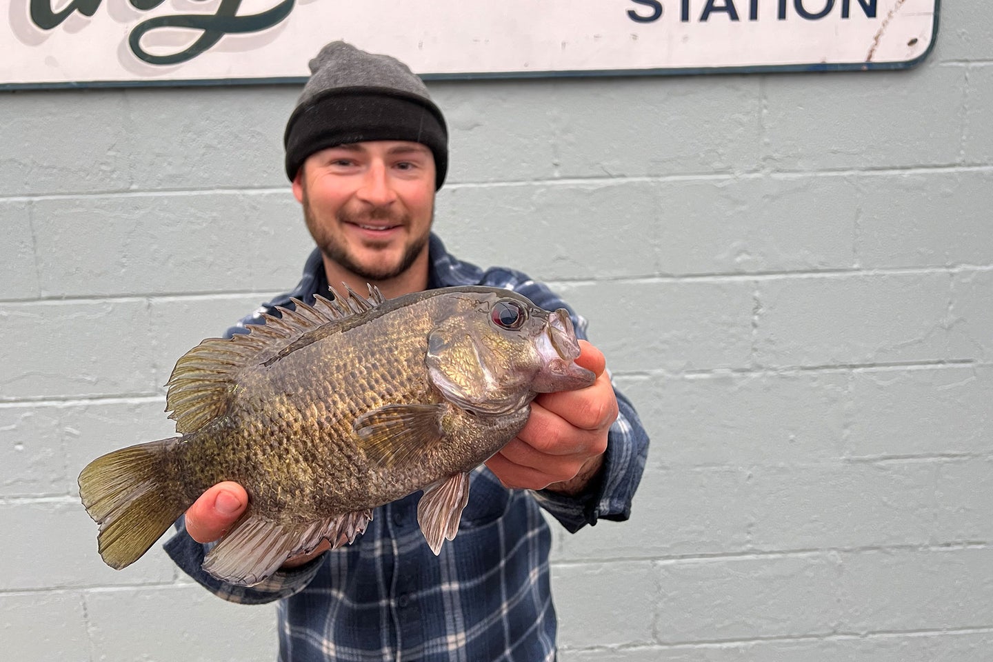 An angler poses with a state-record rock bass.