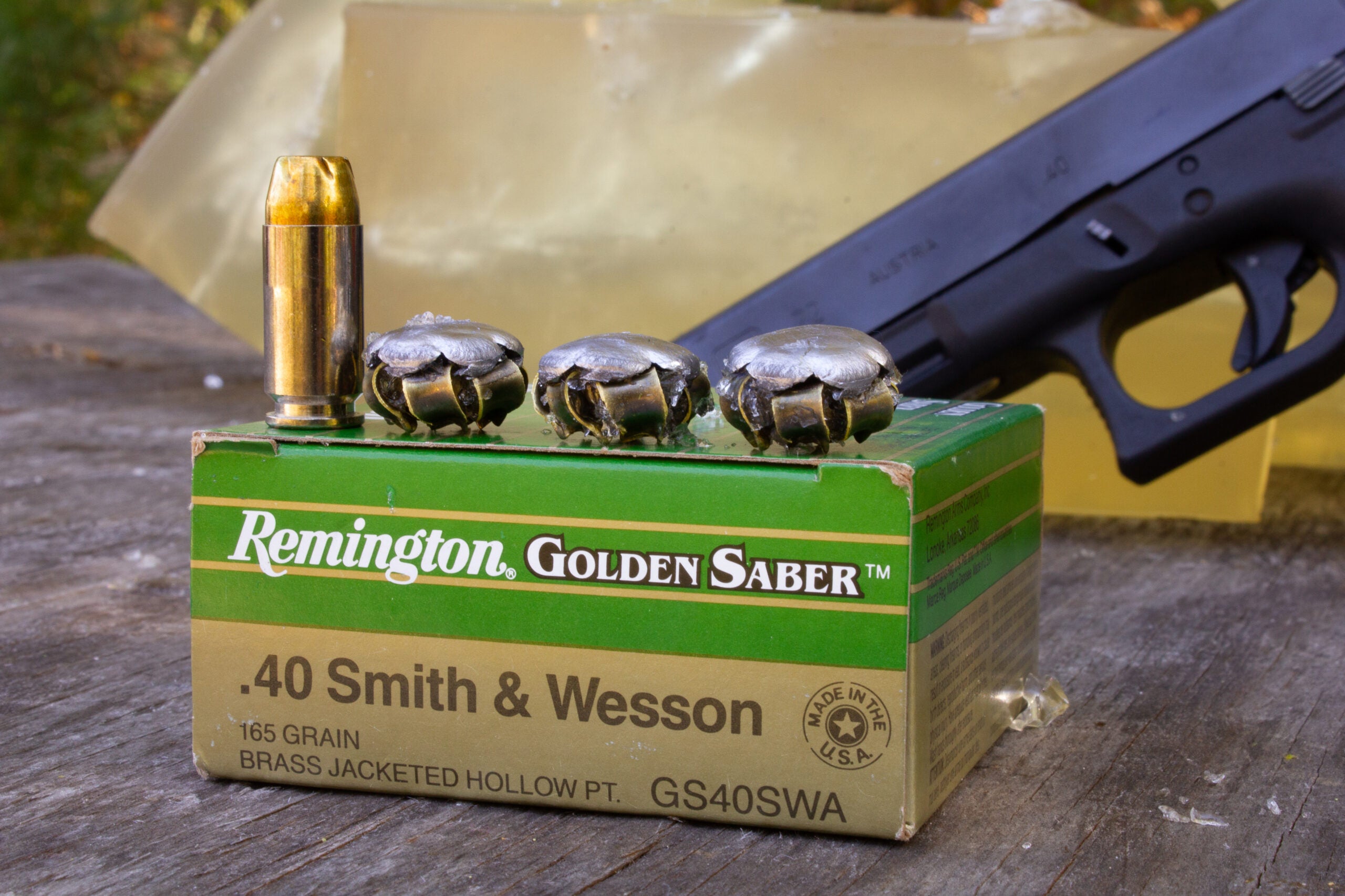 Box of 40 S&W ammo with unfired cartridge and the fired bullets on top
