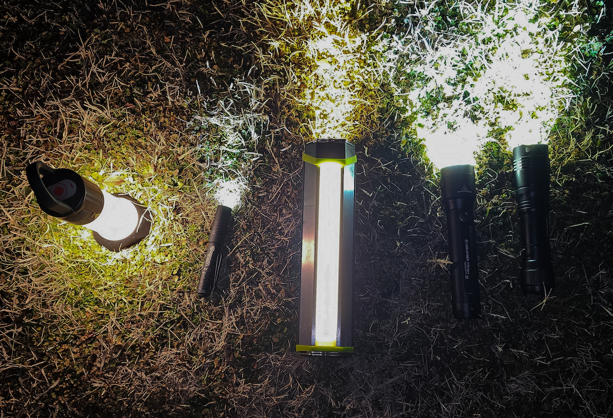 Best camping flashlights lined up on grass at night