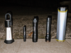 Best camping flashlights lined up on pavement at night