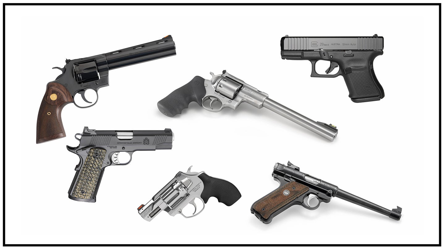 An assortment of six new handguns on a white background