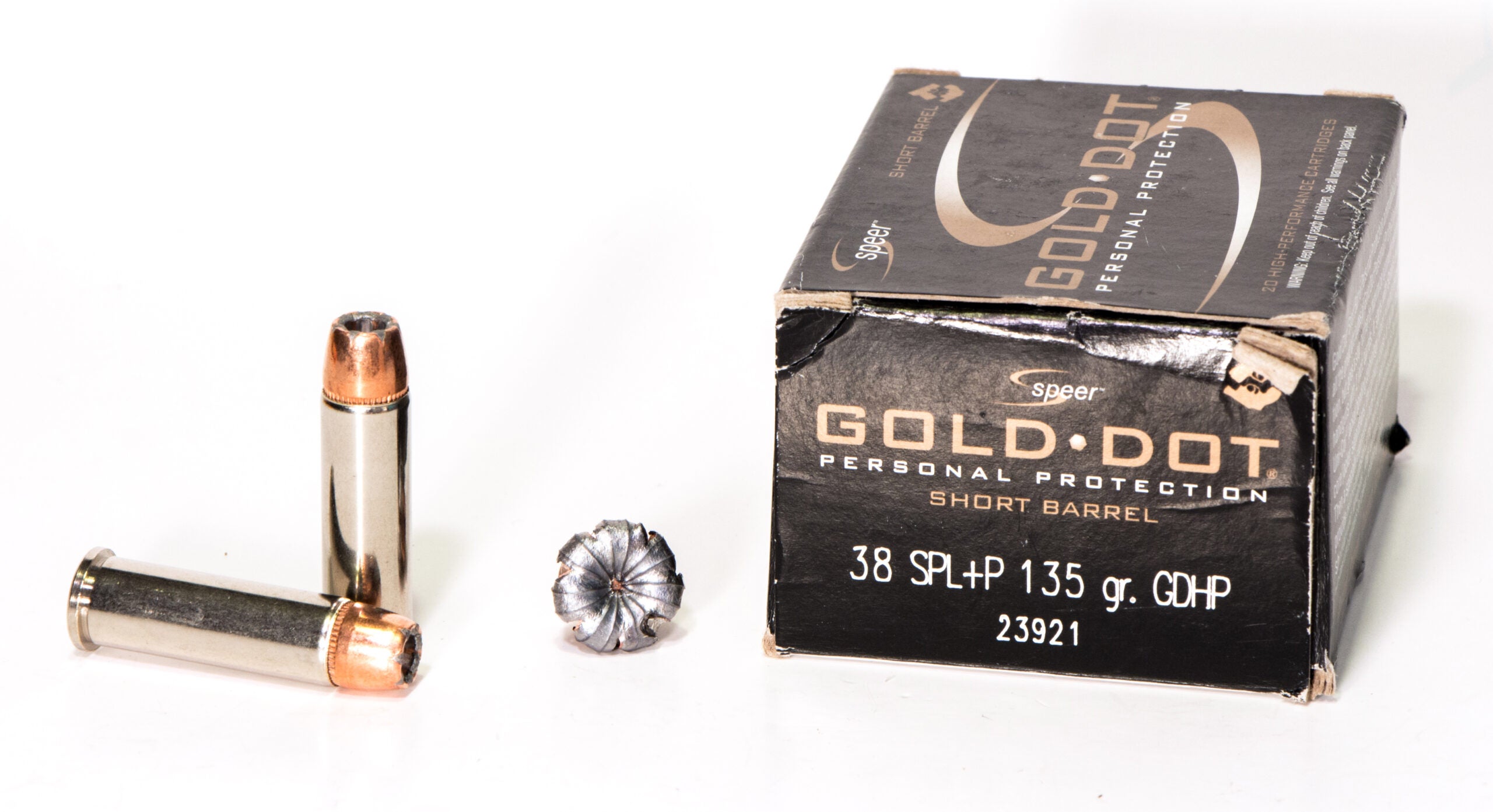 Box of 38 Special ammo with fired bullet and loose cartridges on white background