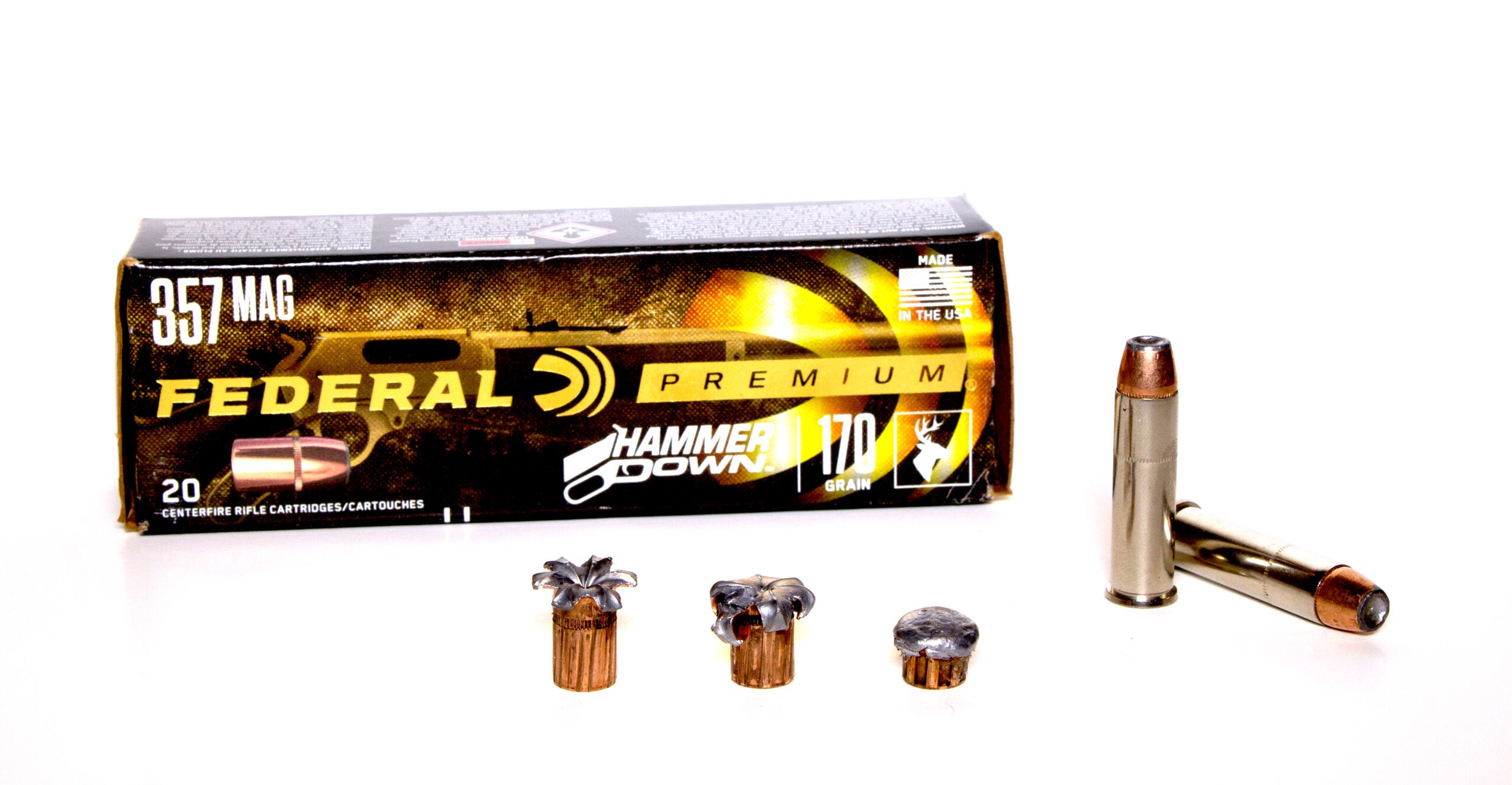 A box of 357 Magnum ammunition with fired bullet and loose rounds on white background