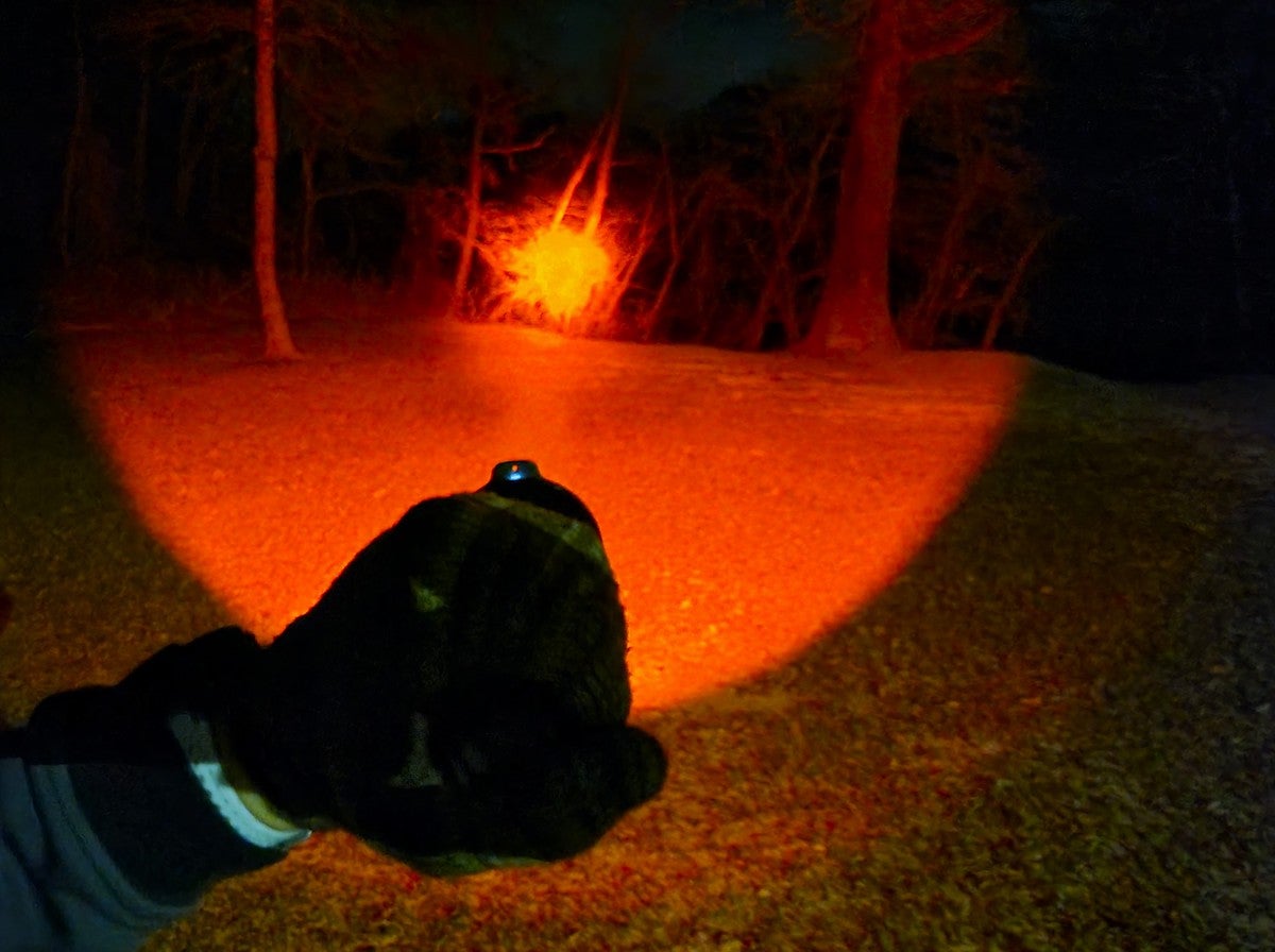 Red beam of Fenix HT18R Long-Distance Flashlight at night