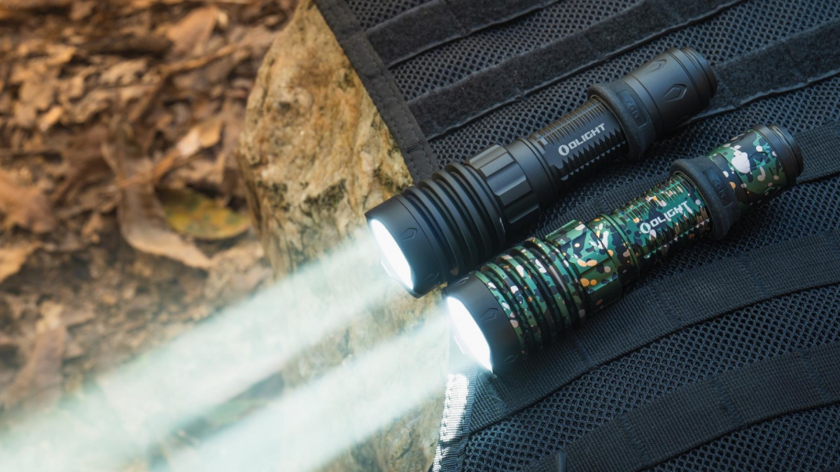 Two Olight flashlights for hunting sitting on pack