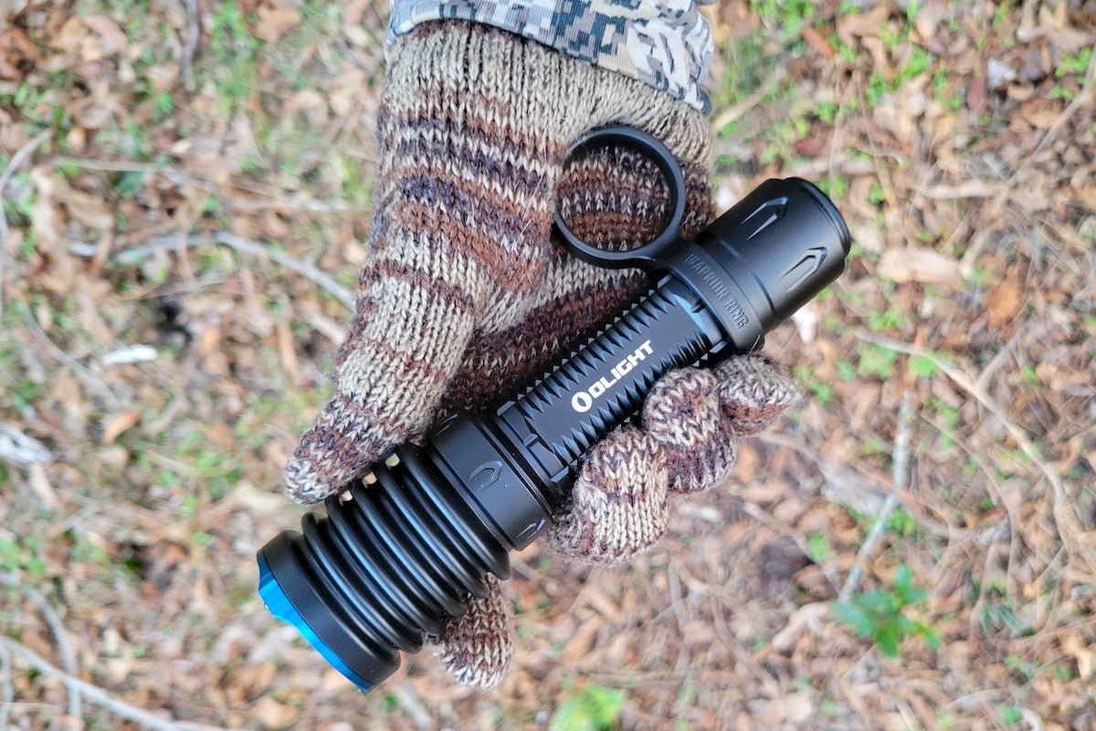 Close-up of hand holding the Olight Warrior X 3 flashlight