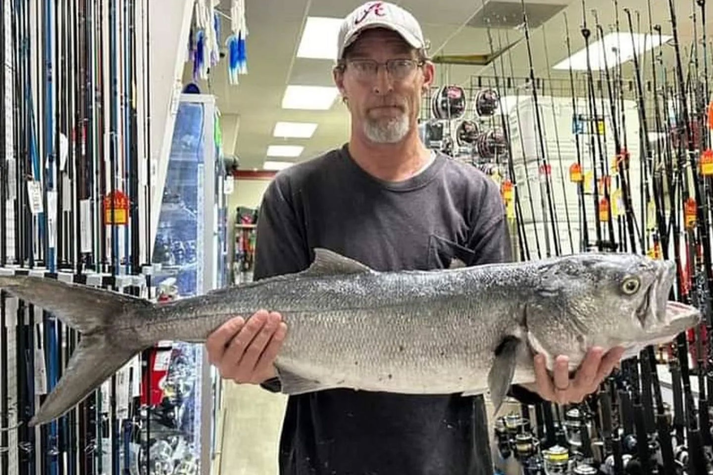 An angler poses with a state record bluefish.