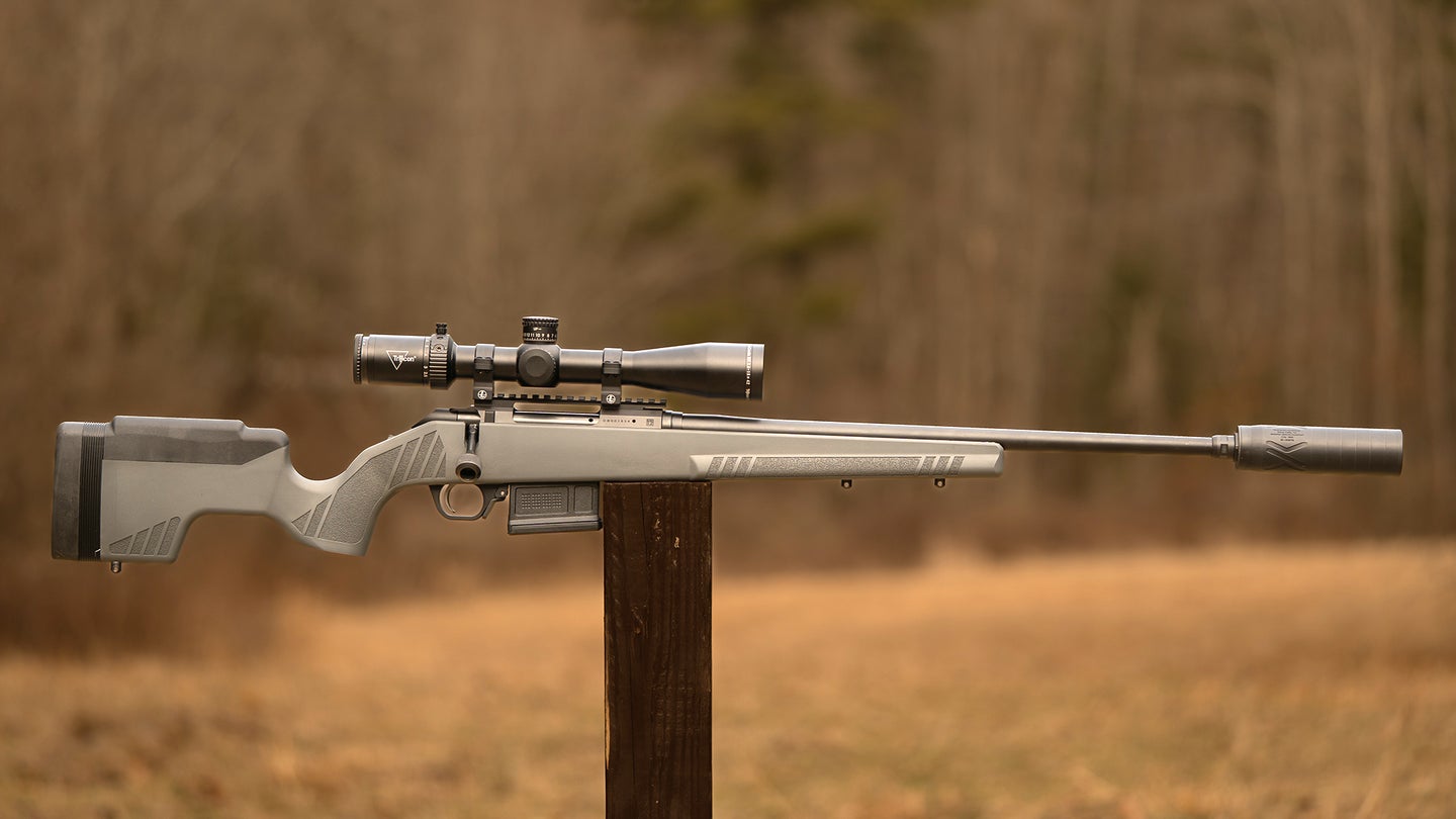 Colt CBX TAC Hunter rifle resting on a post with field in background
