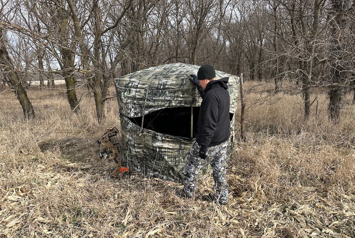 Turkey hunter setting up Primos Double Bull SurroundView Double Wide Ground Blind