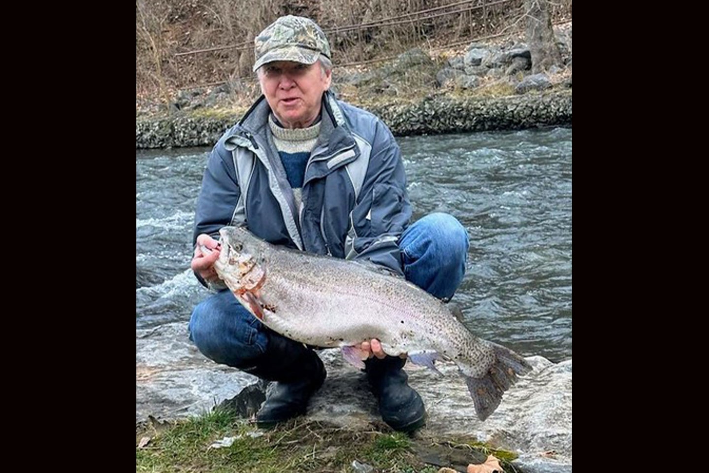 An angler poses with a state-record trout in Maryland.
