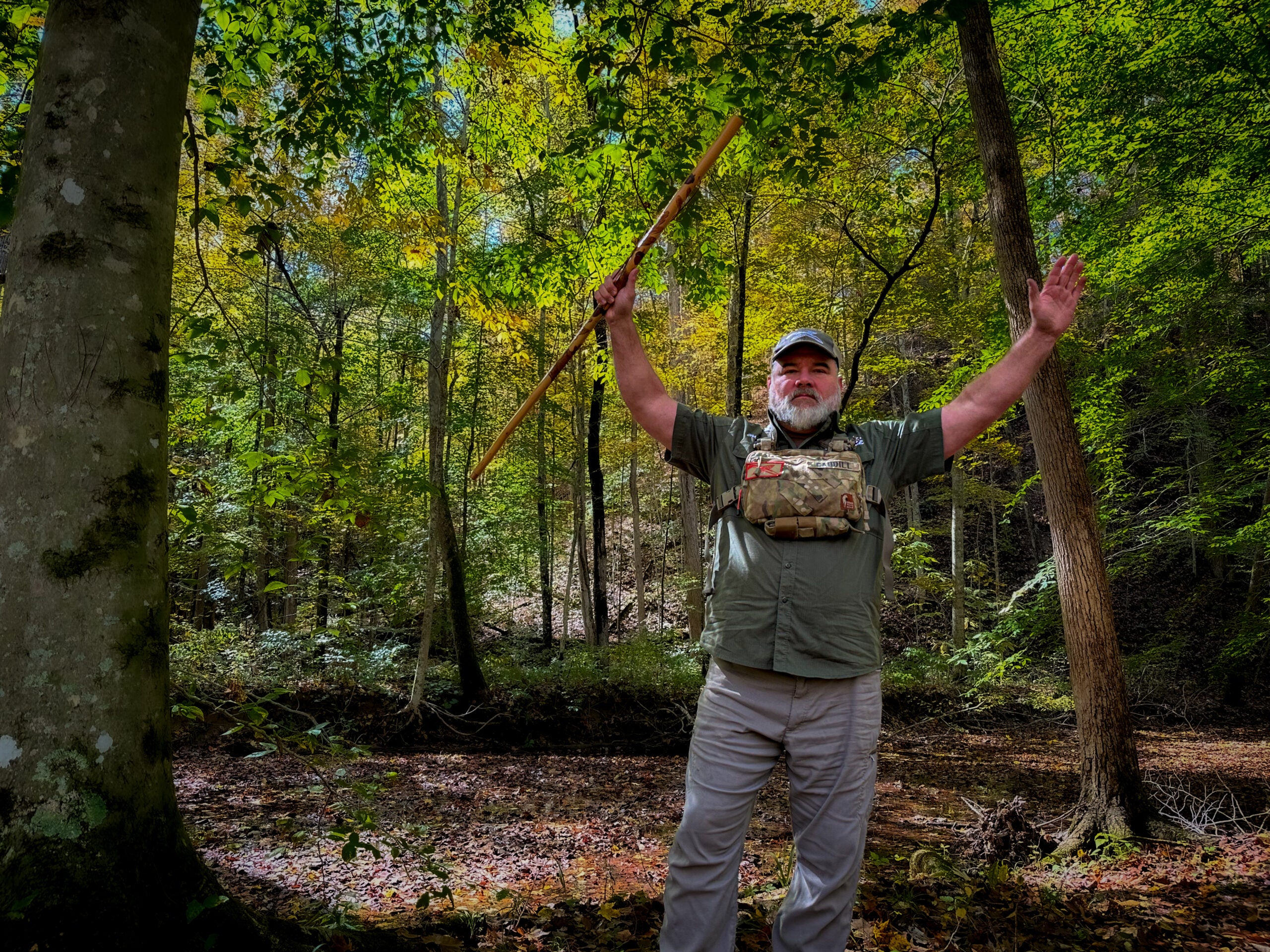 A hiker demonstrates how to wave your arms to prevent a mountain lion attack