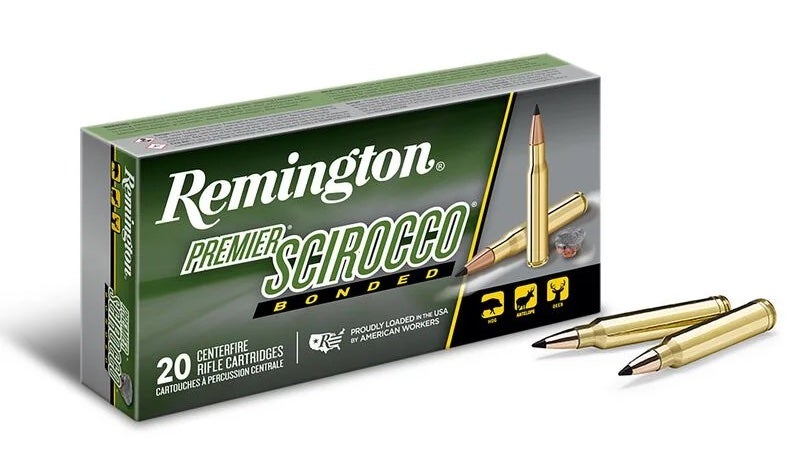 Box of Remington 7mm Rem Mag ammo and two loose cartridges on white background