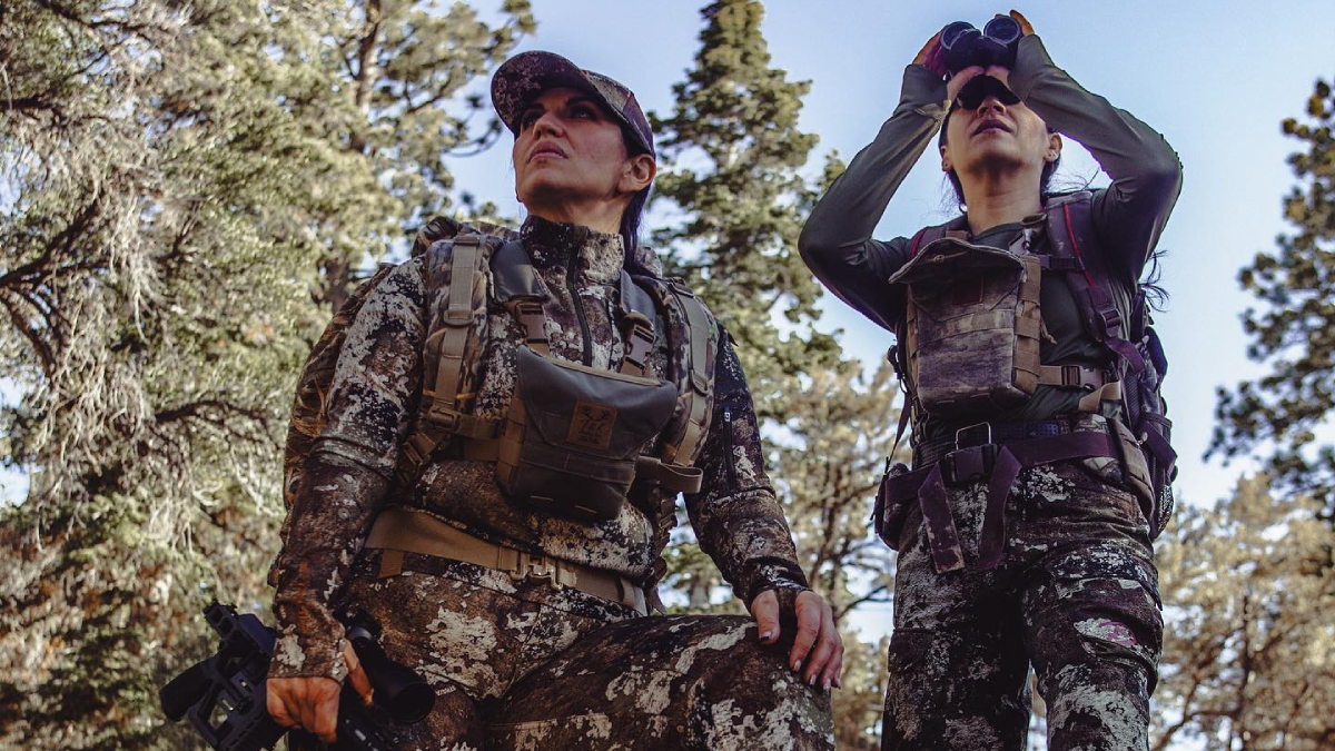 Two female hunters wearing Ditale Outdoors hunting apparel in the woods