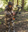 Female hunter wearing Prois hunting camo jacket and pants in the woods