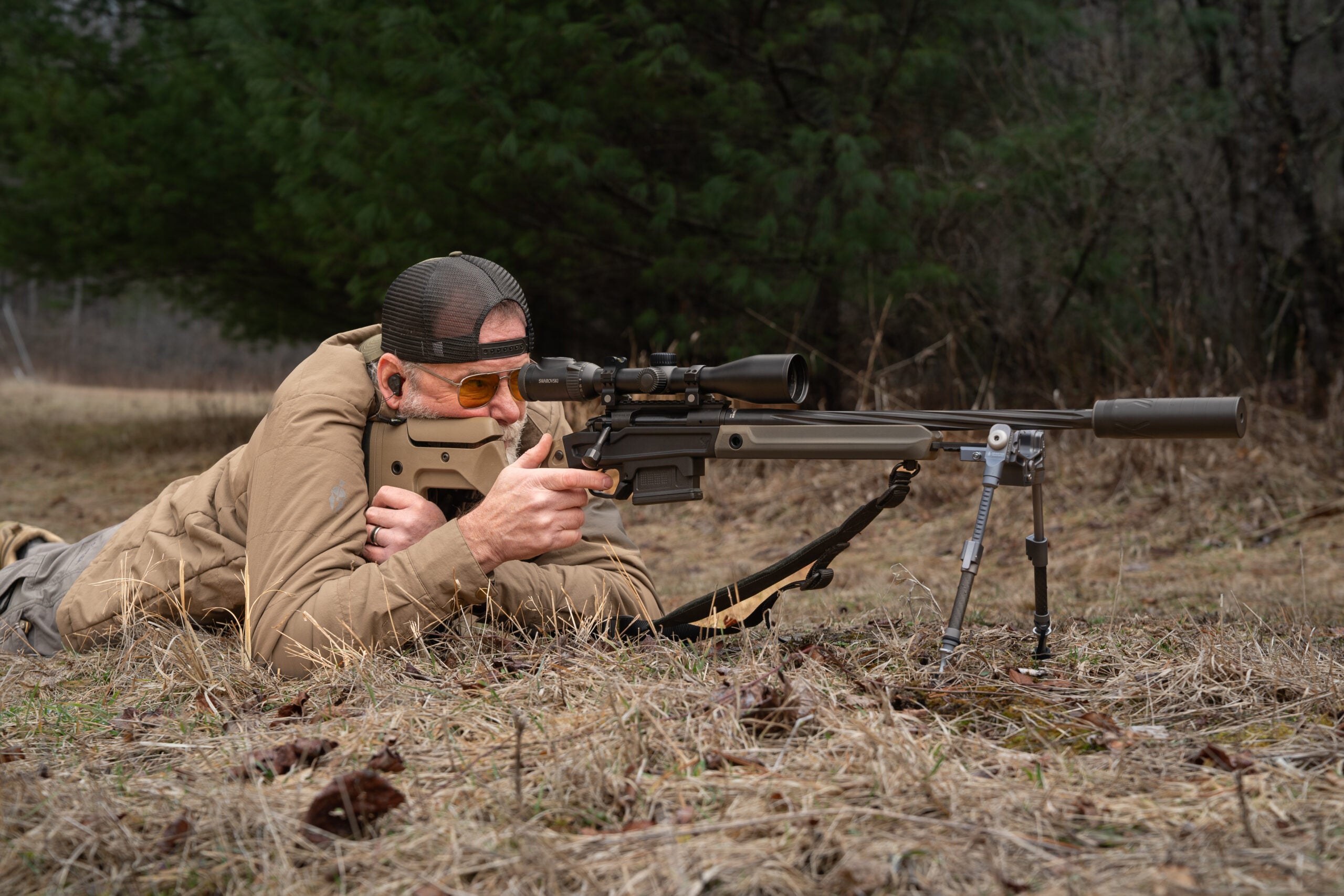 A shooter lays on the ground and shoots the Stag Arms Pursuit Bolt Action Rifle from the prone position