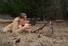 A shooter lays on the ground and shoots the Stag Arms Pursuit Bolt Action Rifle from the prone position