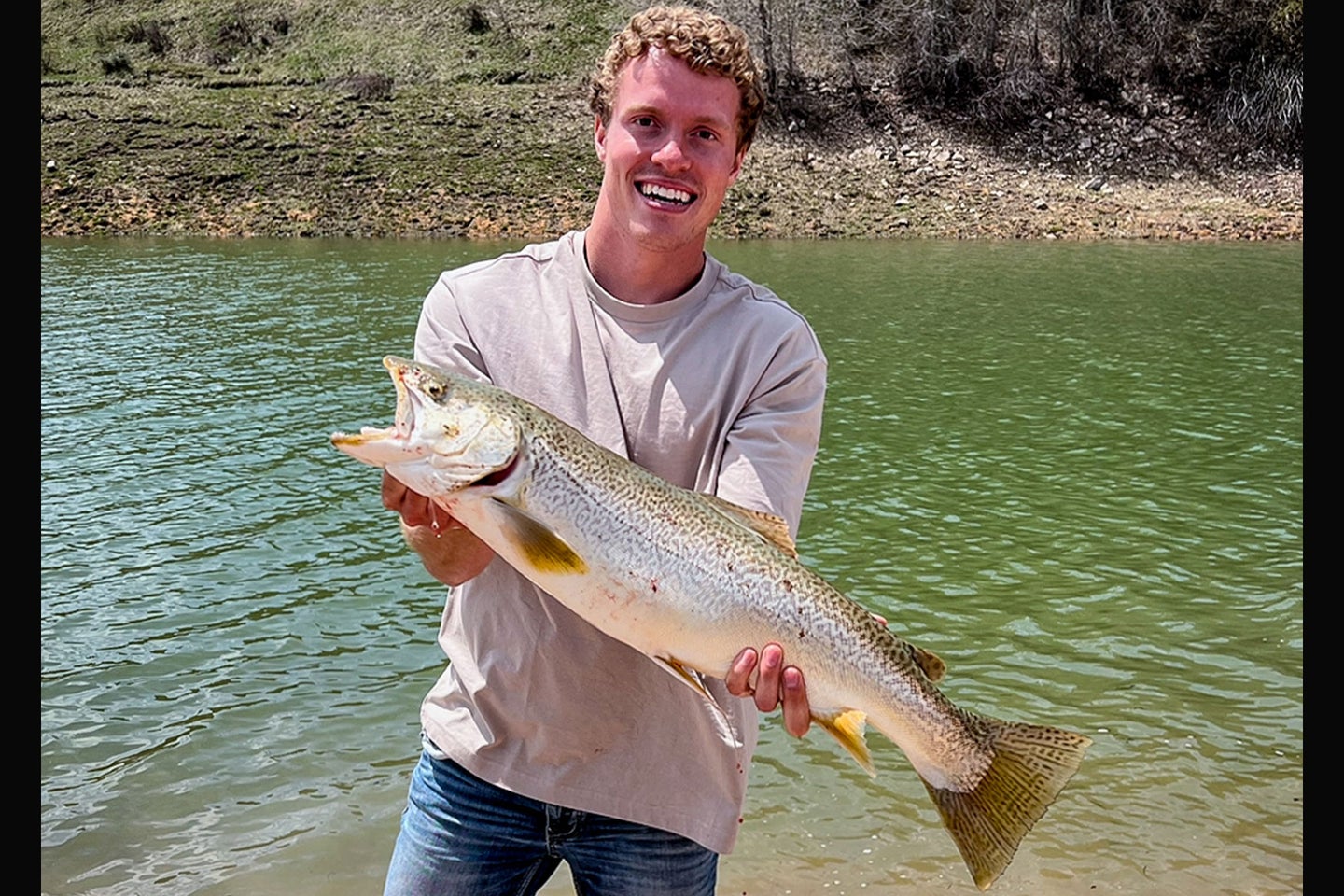 An Idaho angler poses with an illegally-caught trout.