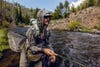 Angler fly fishing on the river wearing Duck Camp jacket