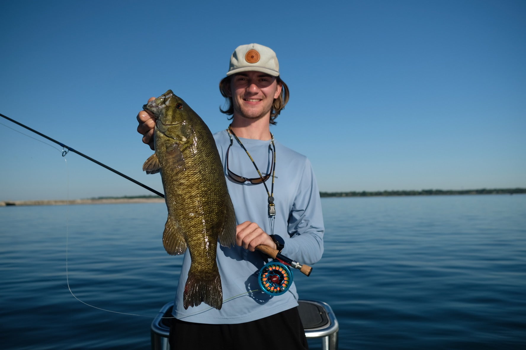 angler holding smallmouth bass