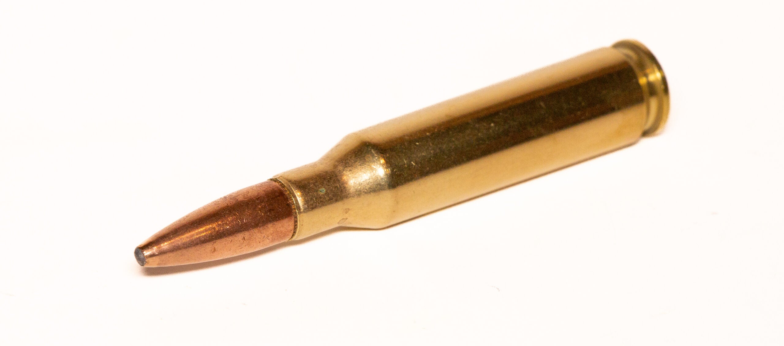 A 7mm-08 Remington cartridge on a white background