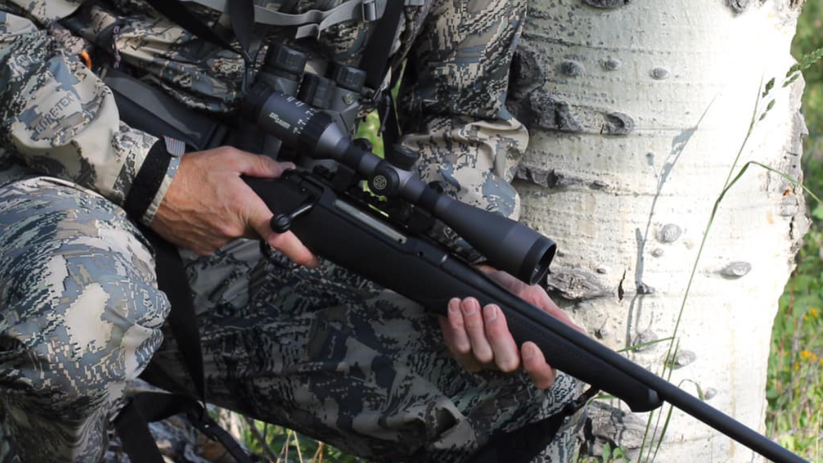 Hunter holding rifle with Sig Sauer Whiskey 3 Rifle Scope mounted on
