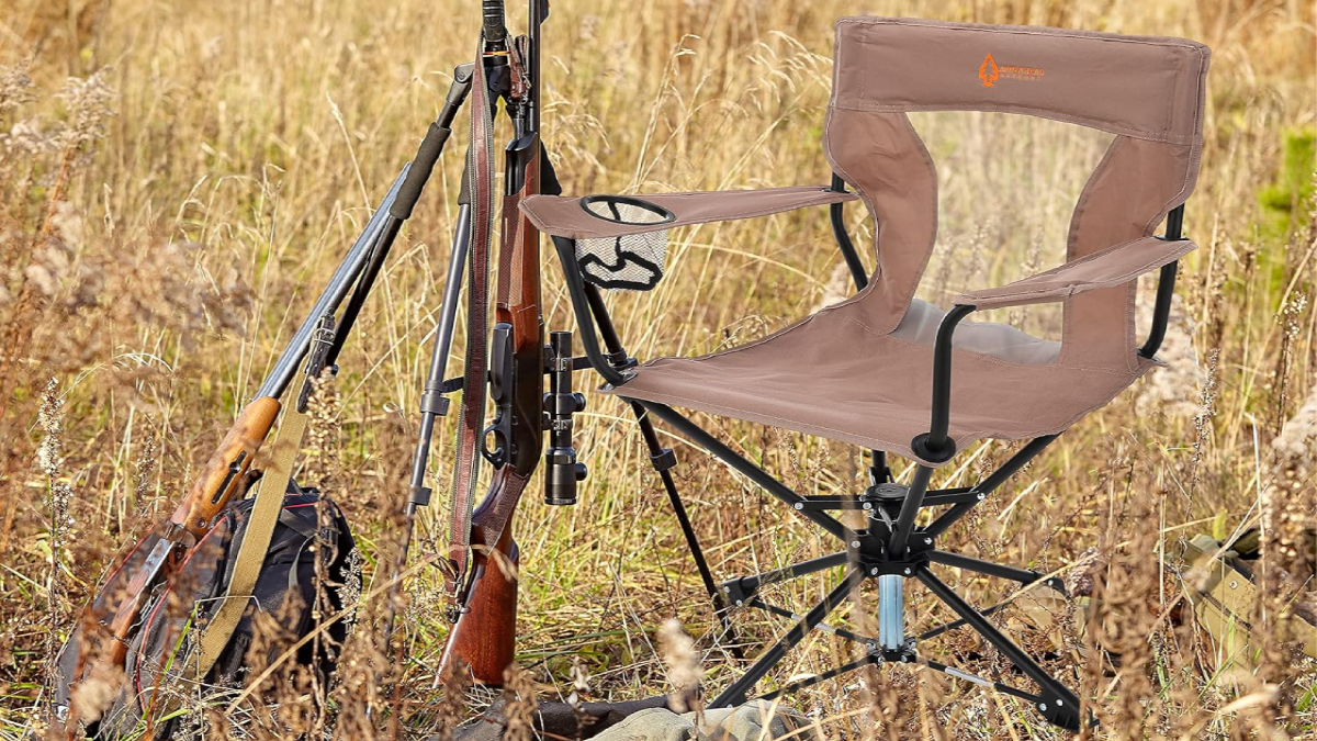 Arrowhead Outdoor Swivel Hunting Chair sitting in grass with rifle