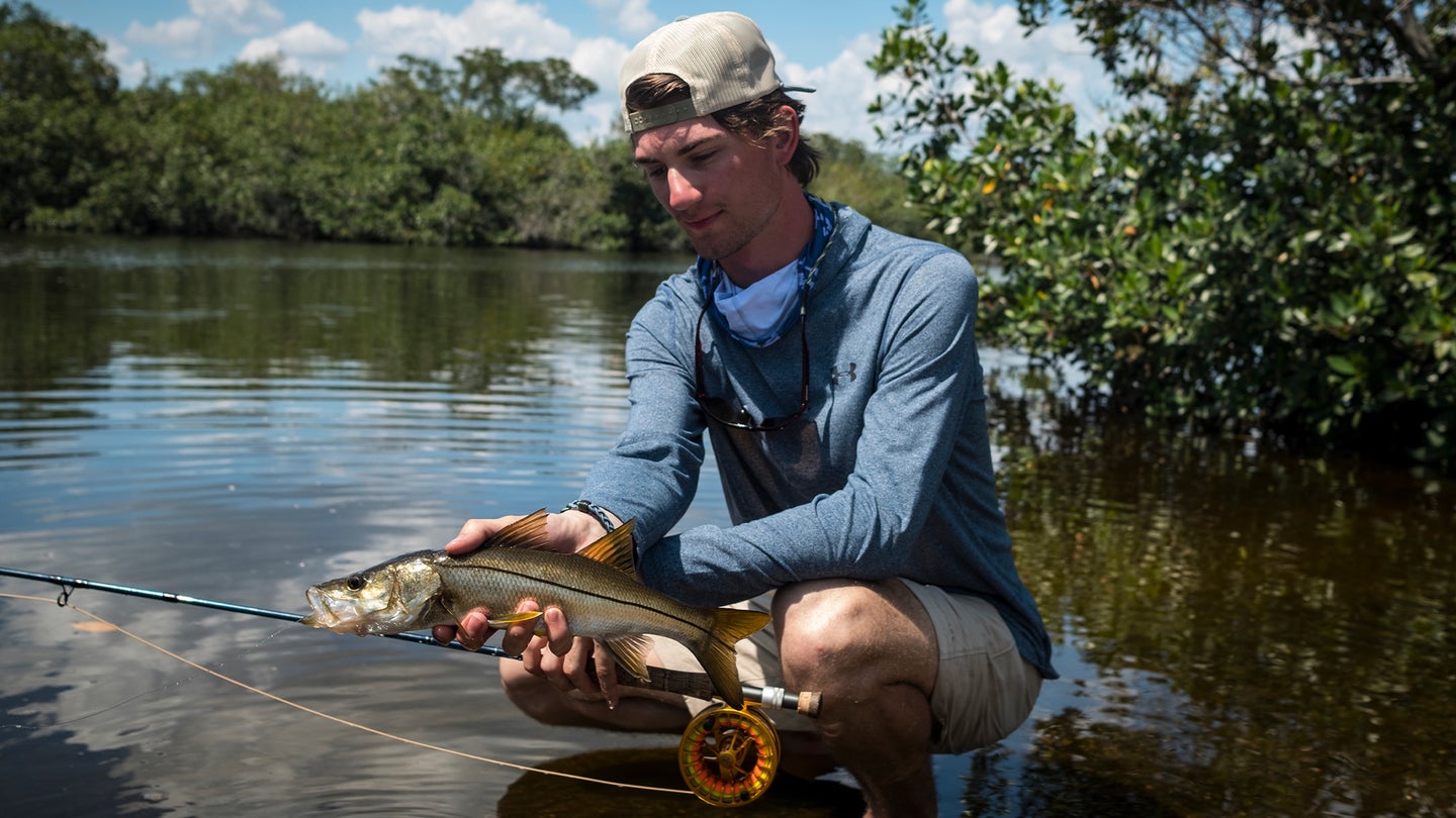 A fly angler holds up a snook caught near Fort Myers, Florida.