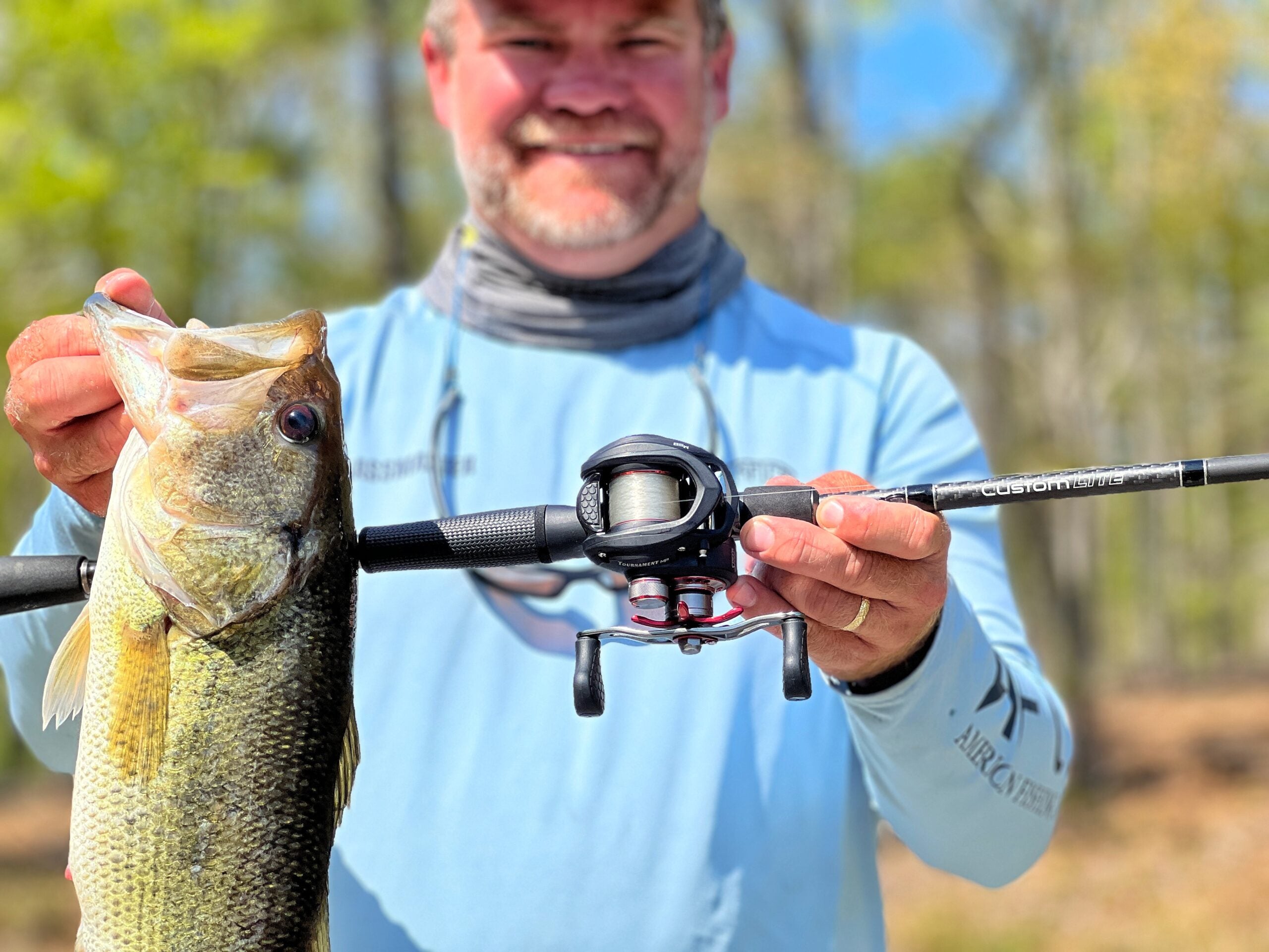 The author holds up a largemouth and the Lew's Custom Series rod during his testing process.